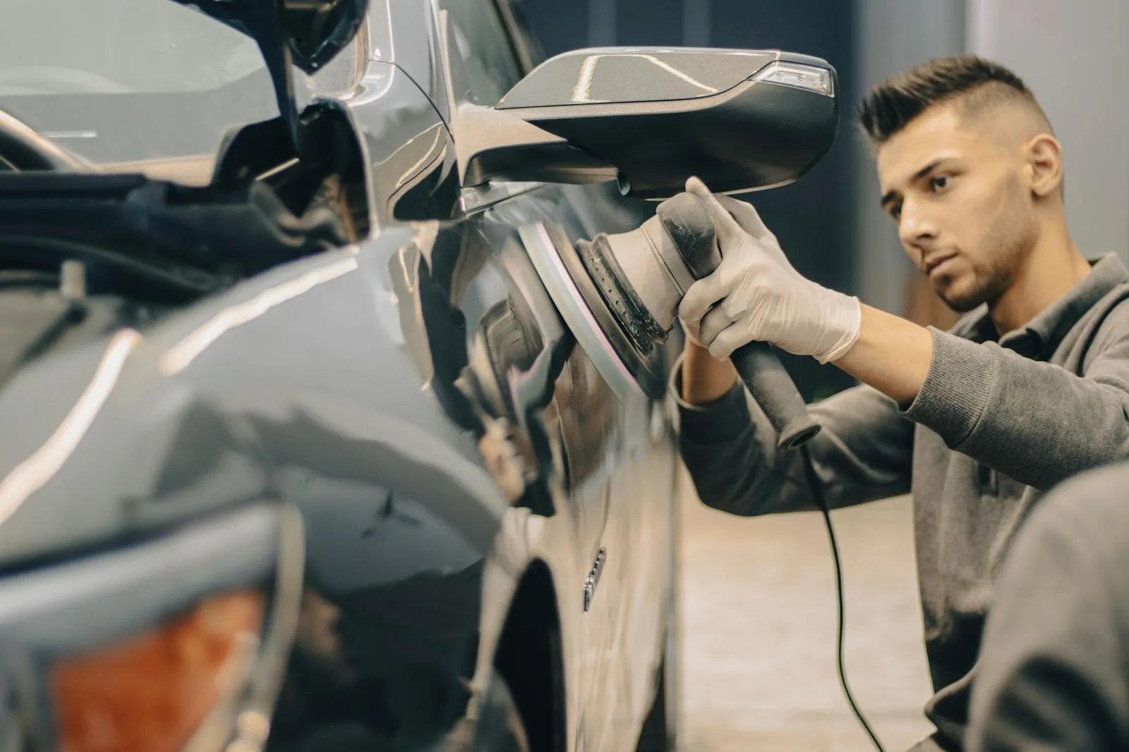 Man Polishing Car during paint correction service
